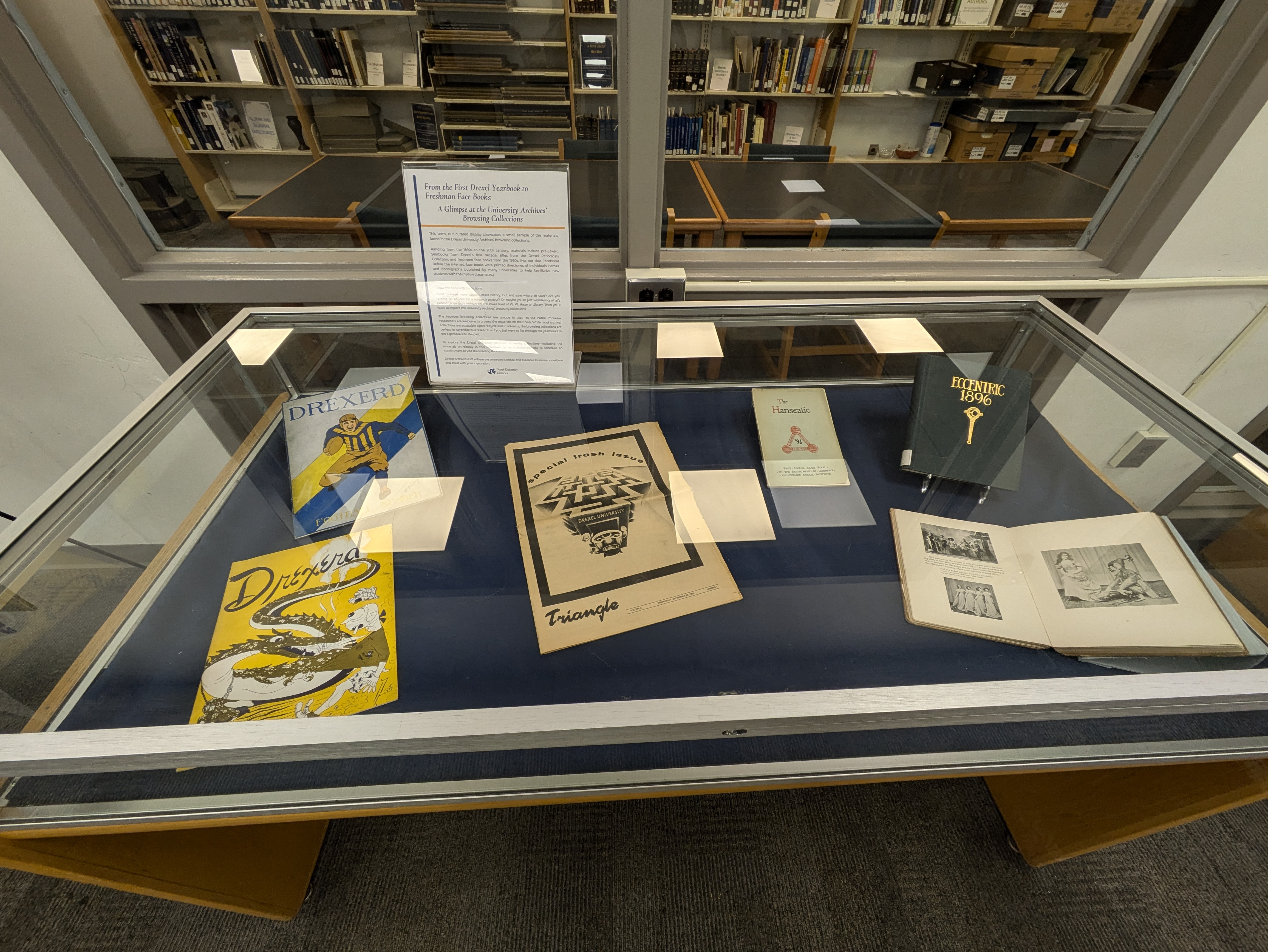 An exhibit case with books on display